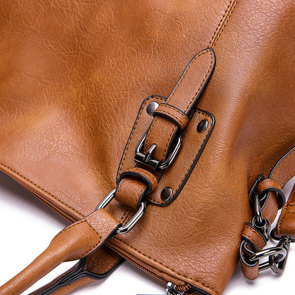 Close-up of a brown leather handbag with chain strap on a white background