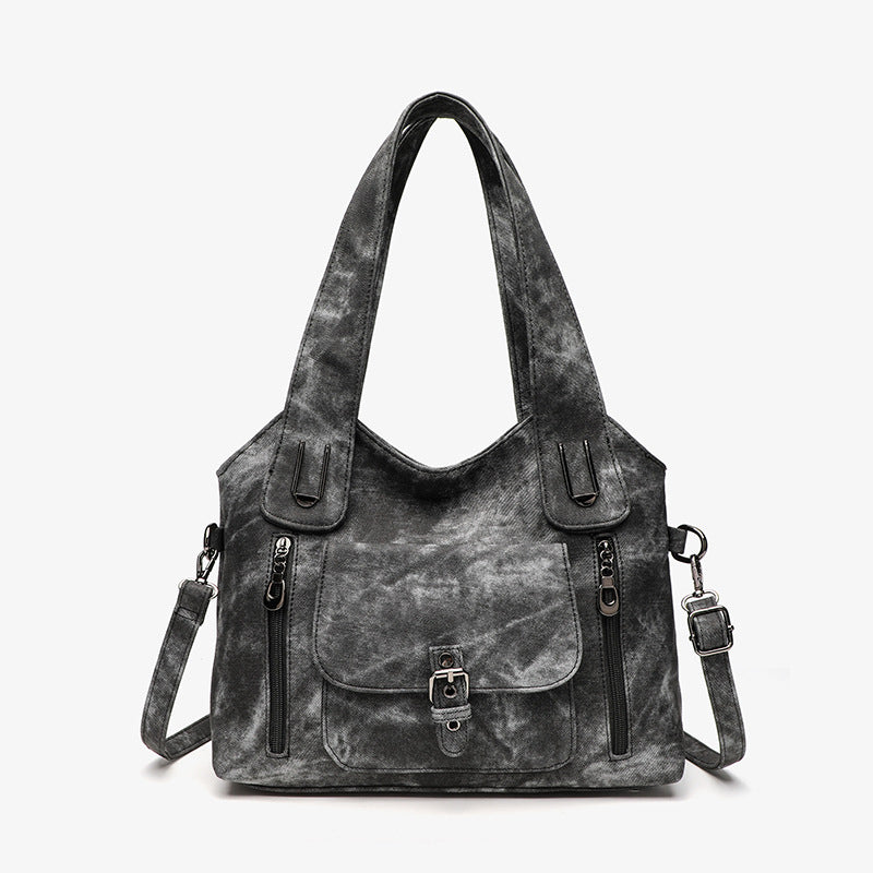 Gray handbag with black accents on a white background