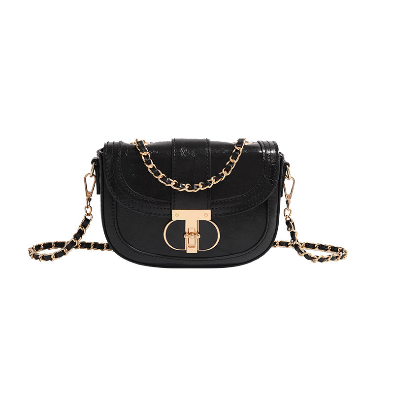 Black handbag with gold chain strap on a white background